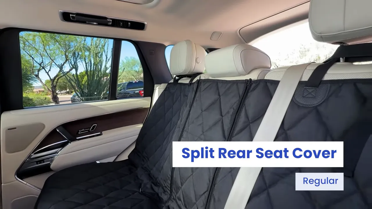 Black split rear seat cover installed across the Range Rover rear bench with center seat belt visible