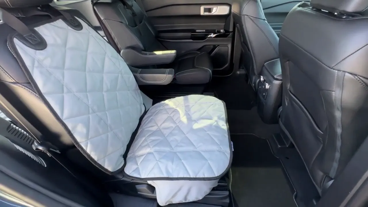 Gray quilted bucket seat cover fitted over a black Ford Explorer captain's chair