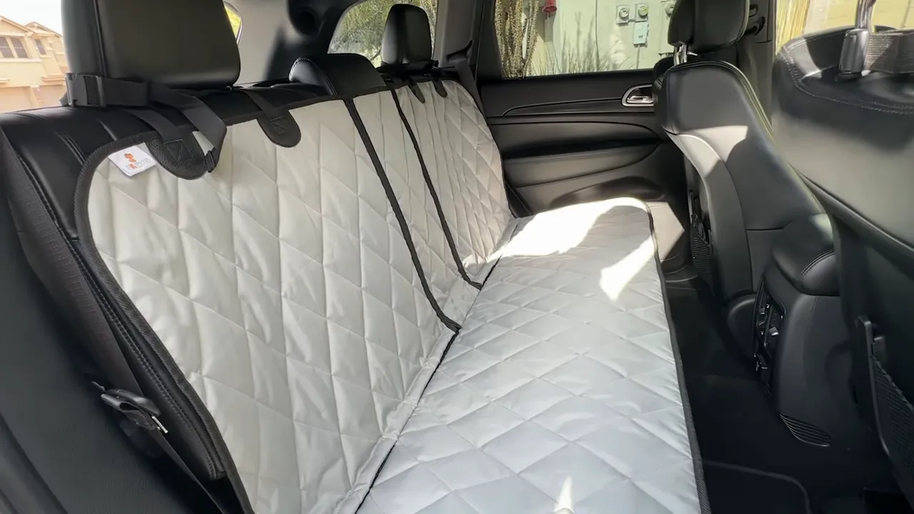 Gray quilted split rear seat cover installed across the Jeep Grand Cherokee rear bench