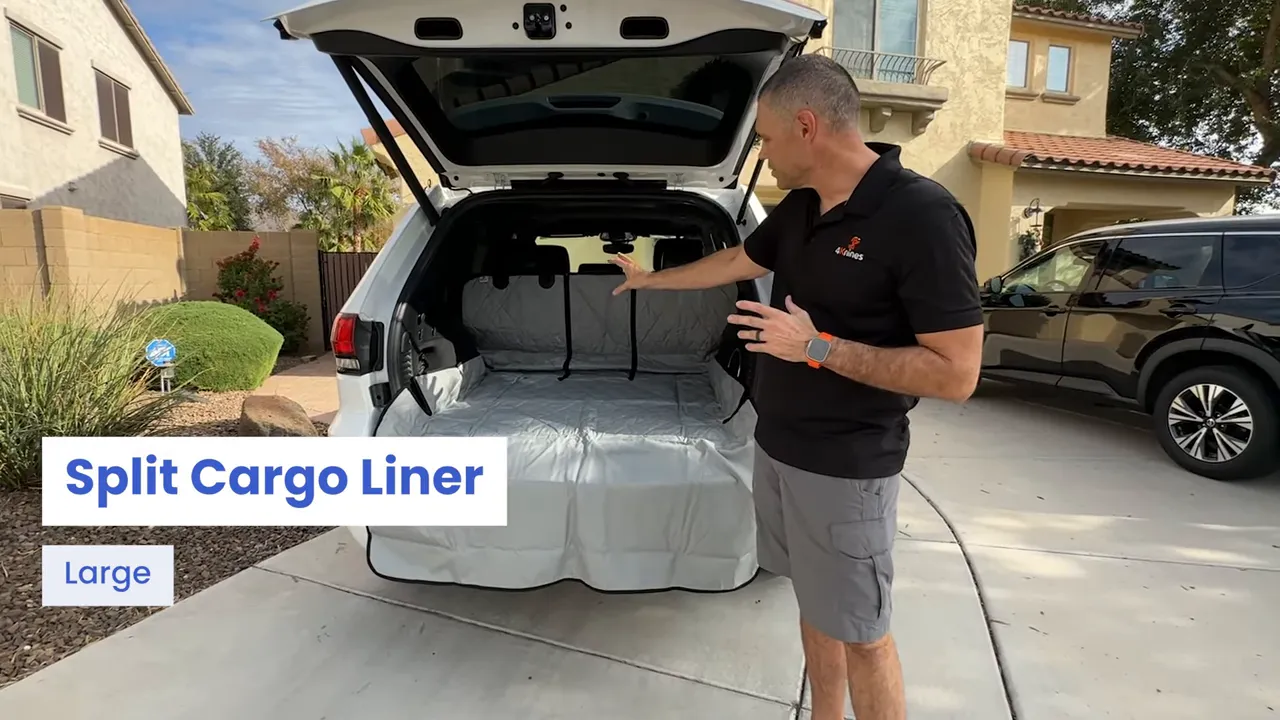 Open Jeep Grand Cherokee cargo area with gray split cargo liner and bumper flap