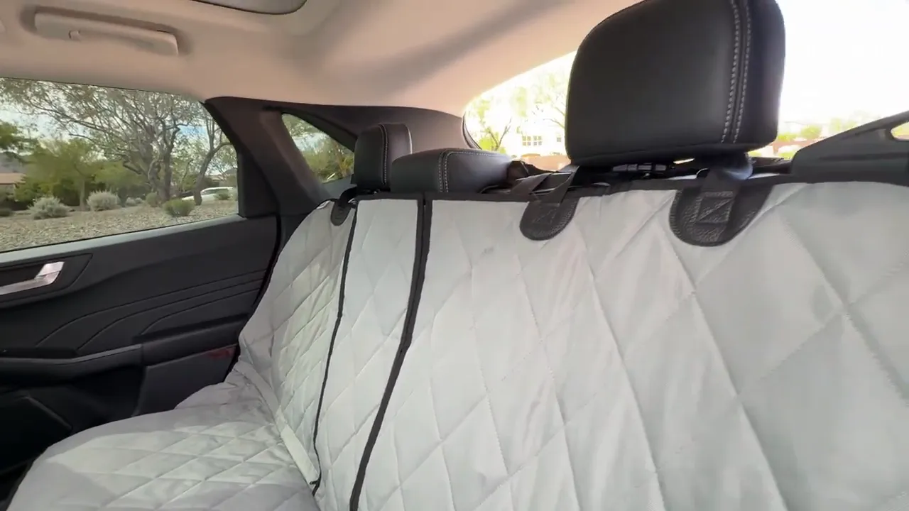 Gray quilted split rear seat cover installed across the Ford Escape rear bench with center zippers visible