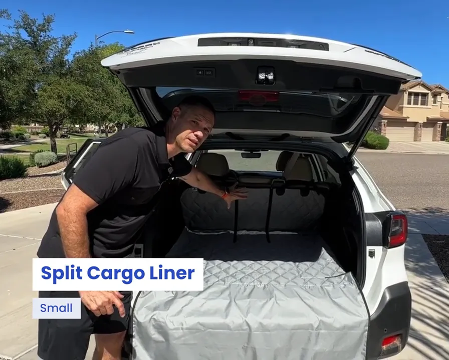 Open Subaru Outback cargo area with a gray quilted split cargo liner and bumper flap