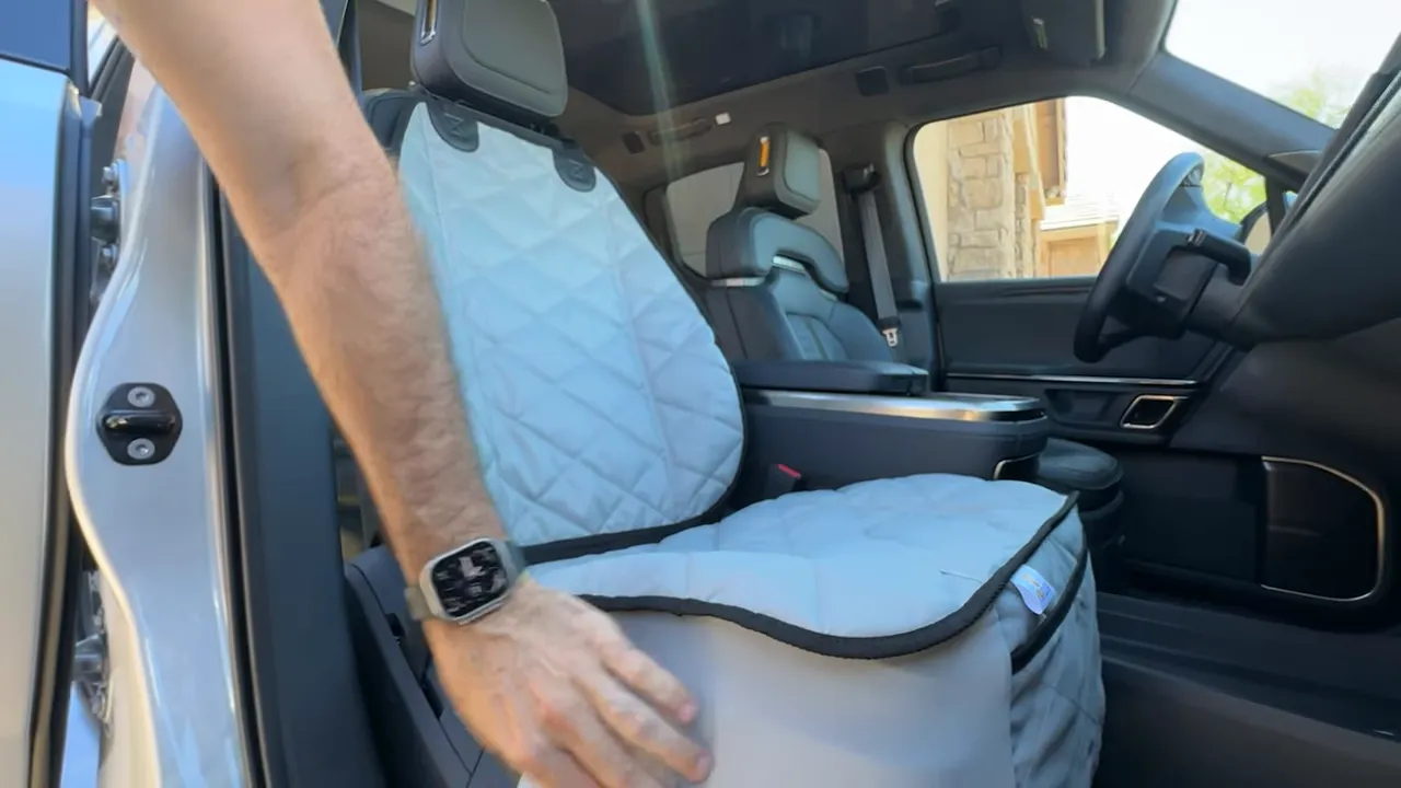 Gray stretch skirt wrapped around the lower portion of the Rivian R1T front seat cover