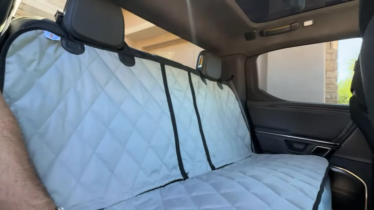 Gray quilted rear seat cover fitted across the Rivian R1T rear bench