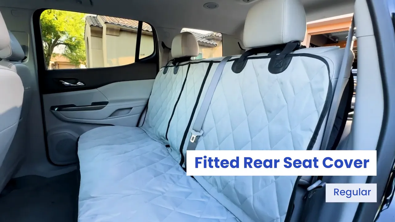 Gray fitted rear seat cover installed across the GMC Acadia second-row bench with visible center seat belt