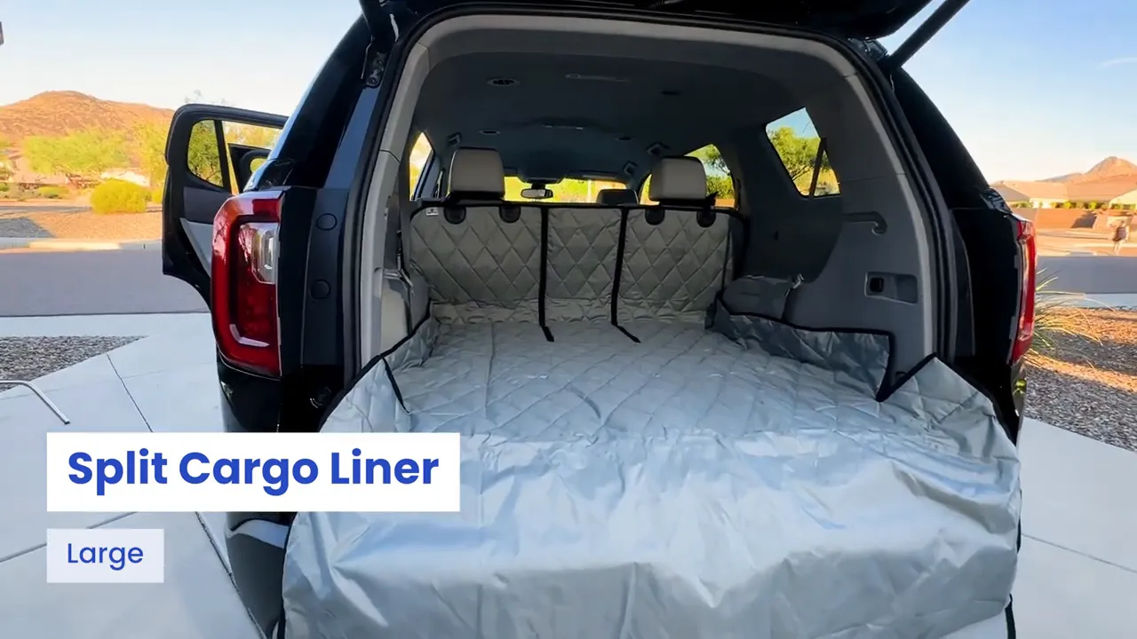Open GMC Acadia cargo area covered by a gray 4Knines split cargo liner with bumper flap