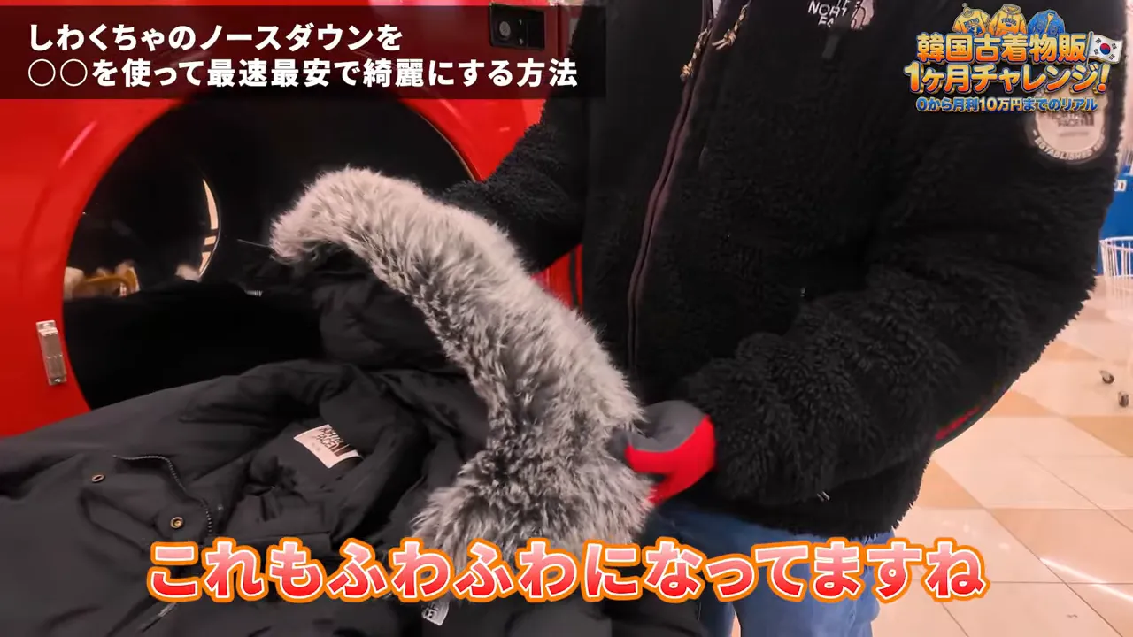 ダウンジャケットのフードのファーを触ってふわふわになっているか確かめる様子