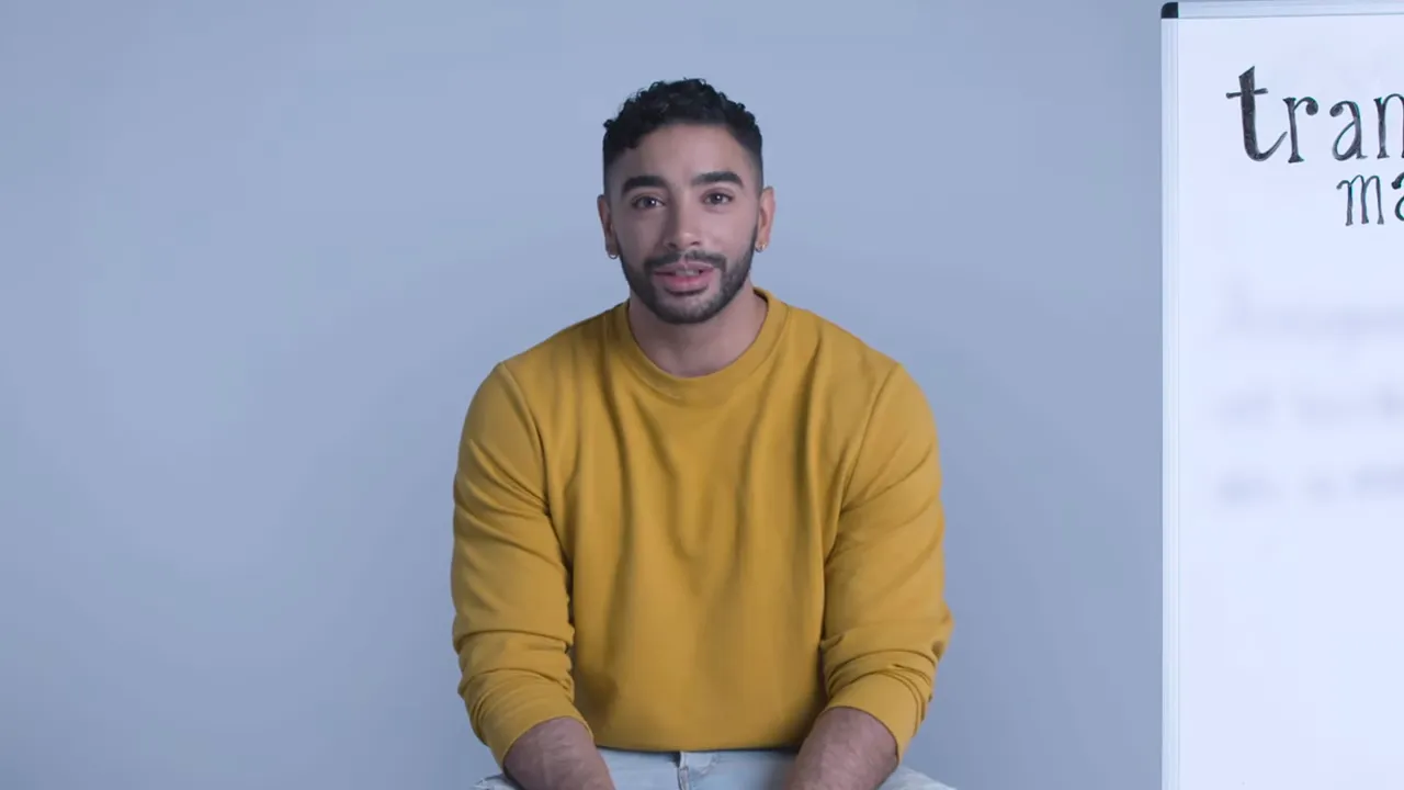 Presenter speaking with the whiteboard “transgender male” visible