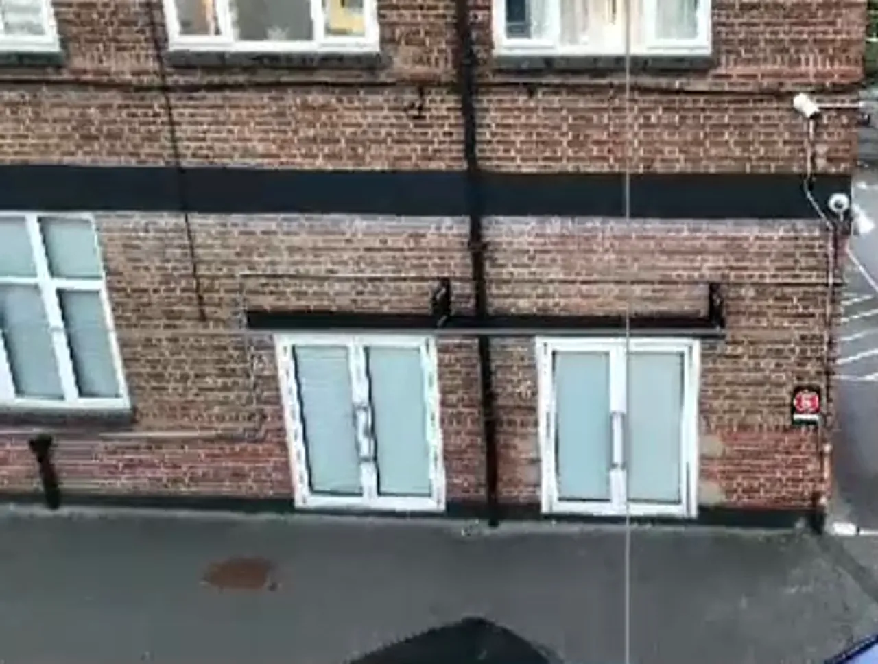 high-clarity drone image of brick facade with windows and doors demonstrating overlap and framing