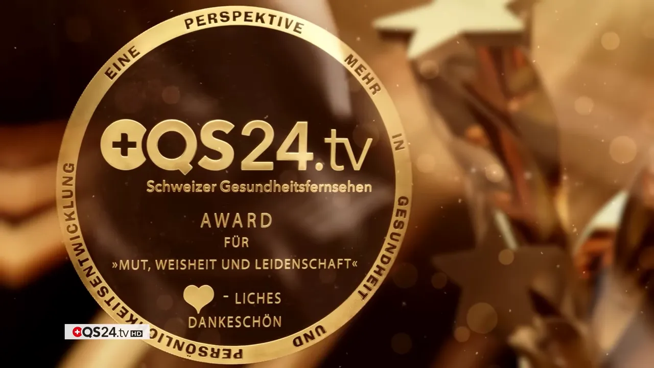 QS24 AWARD 2025: Versöhnung in der Medizin — Preisträgerinnen und Preisträger 7 Goldenes QS24.tv Award‑Medaillon mit dem Text 'Award für Mut, Weisheit und Leidenschaft' vor warmem Hintergrund