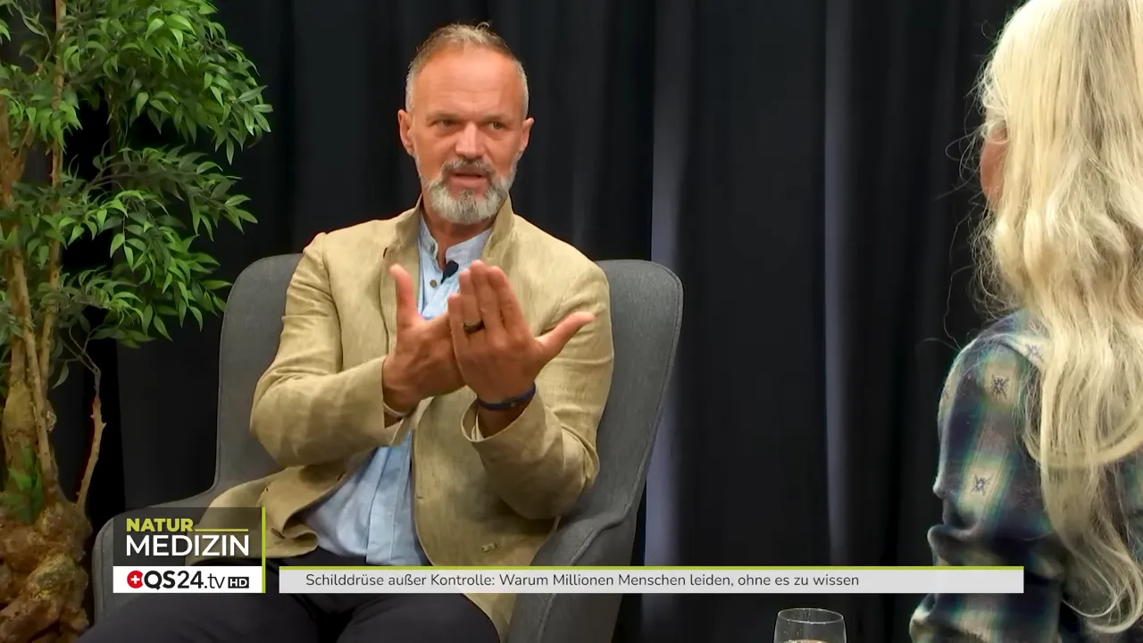Wie die Schilddrüse Ihr Leben bestimmt - Interview mit Dr. Markus Stark, Ernährungsexperte und Dozent für Psycho‑Neuro‑Immunologie 8 Experte gestikuliert erklärend im Studio, Moderatorin im Profil