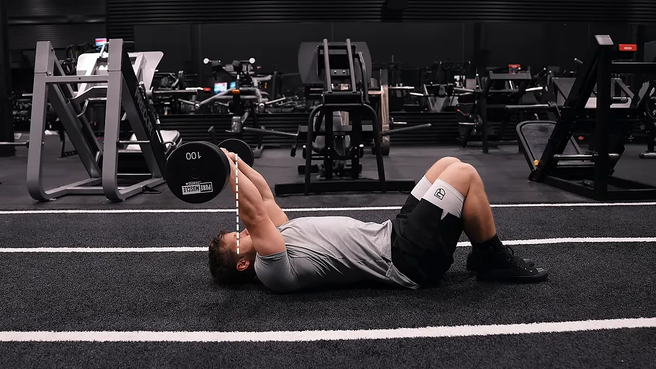 Side view of a floor skull crusher with the arms extended and the bar behind the lifter's eye line