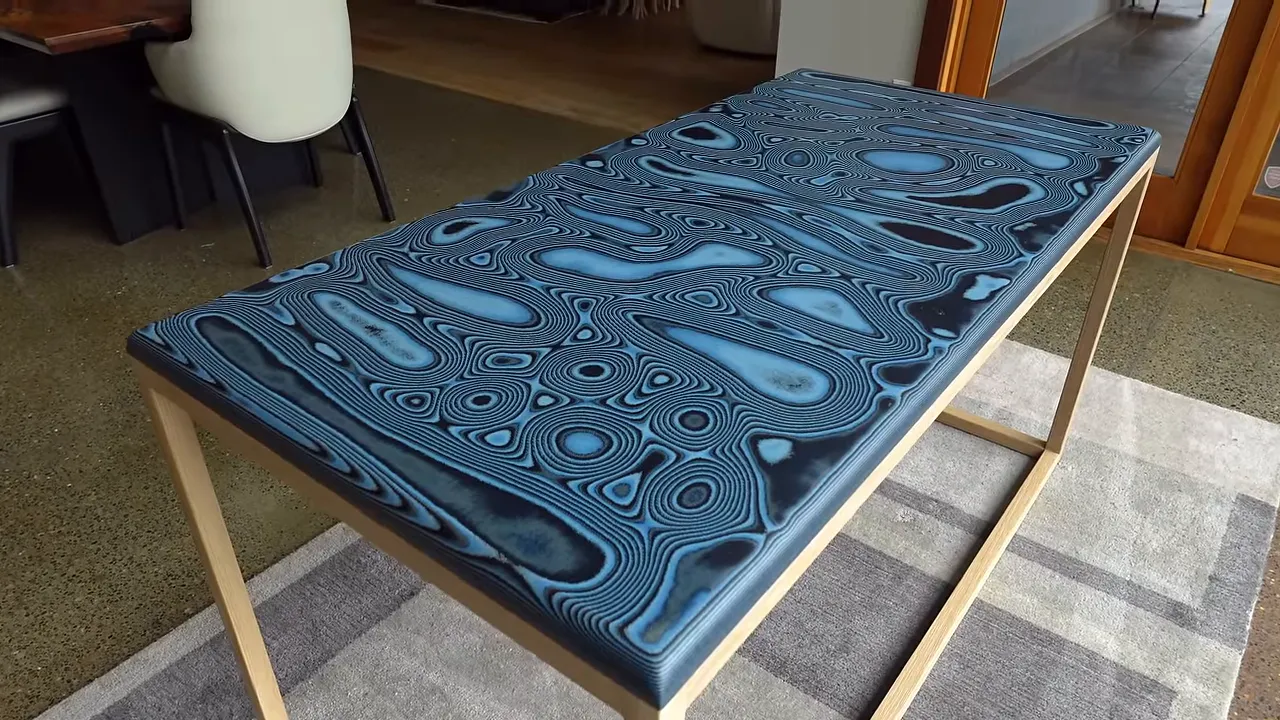 Finished blue patterned denim desk on a minimalist white oak frame