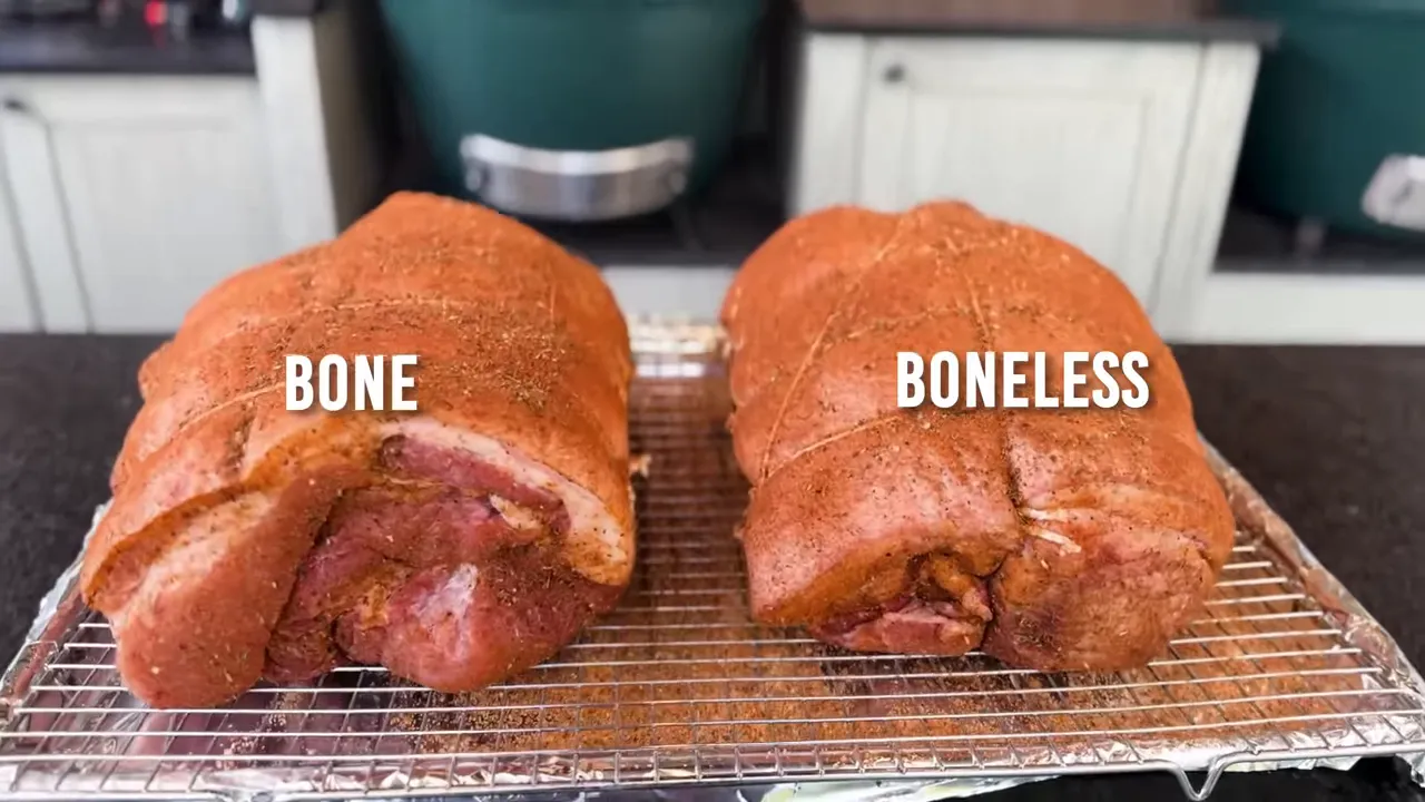 Two seasoned pork shoulders on a wire rack labeled bone and boneless