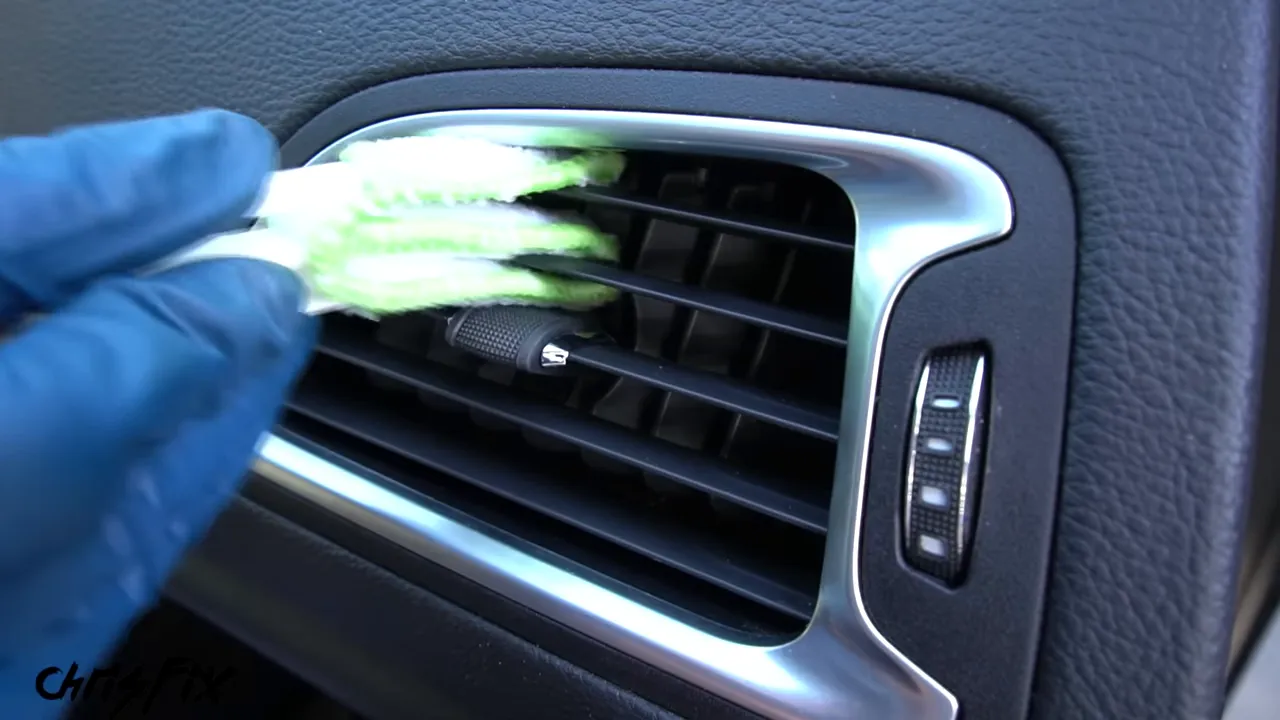 Microfiber vent-cleaning fingers positioned between dashboard vent fins