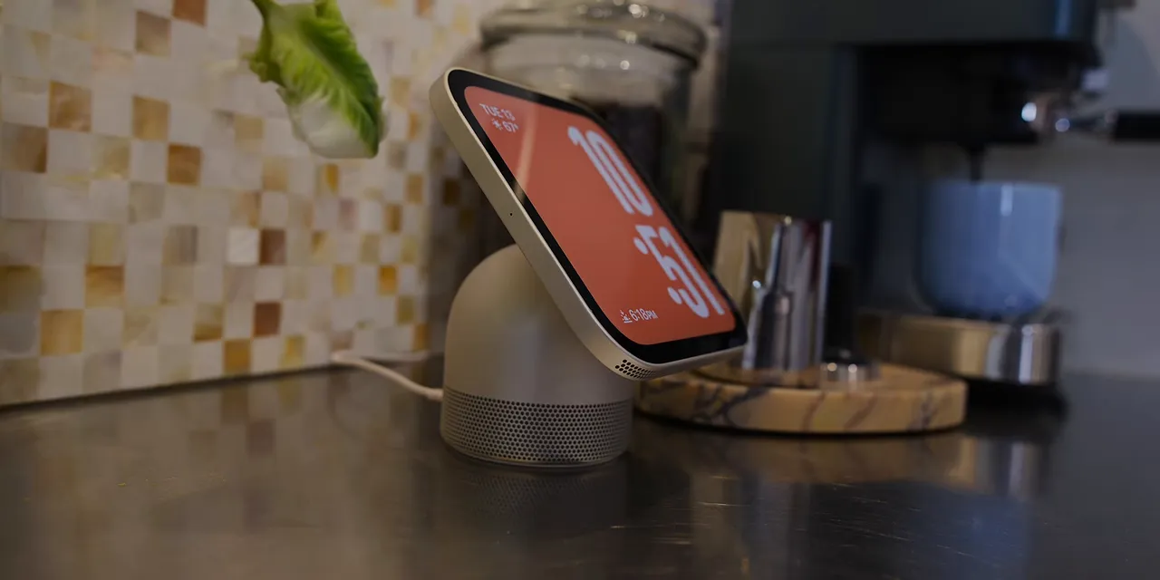 Side view of HomeView on a kitchen counter showing its tilted display and rounded metal base