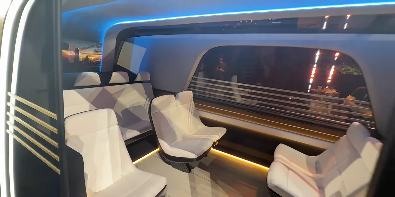 Open Robovan doorway revealing rows of light-colored seats and blue interior lighting
