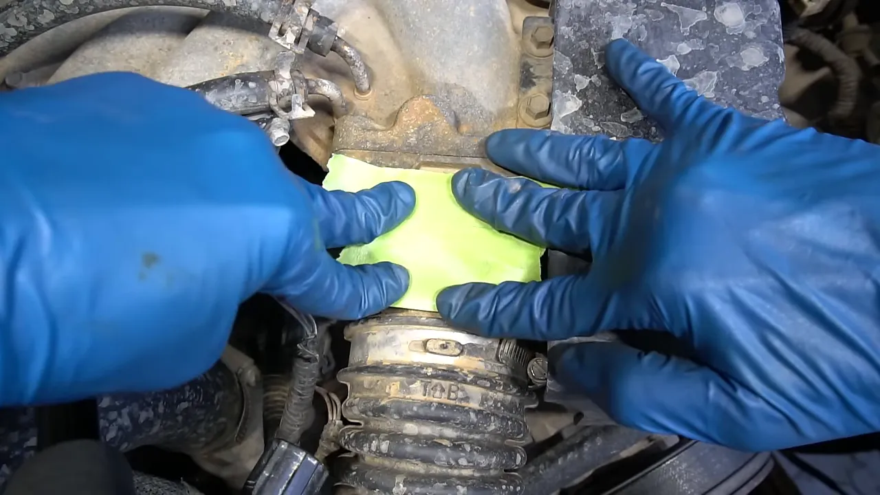 Green tape covering the pickup's exposed idle air control valve mounting opening