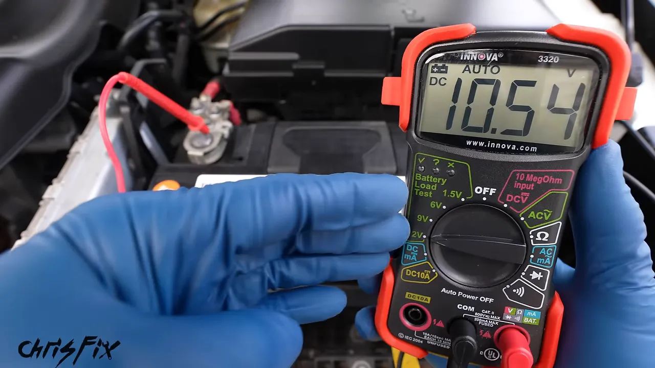 Multimeter displaying 10.54 volts while connected to a car battery