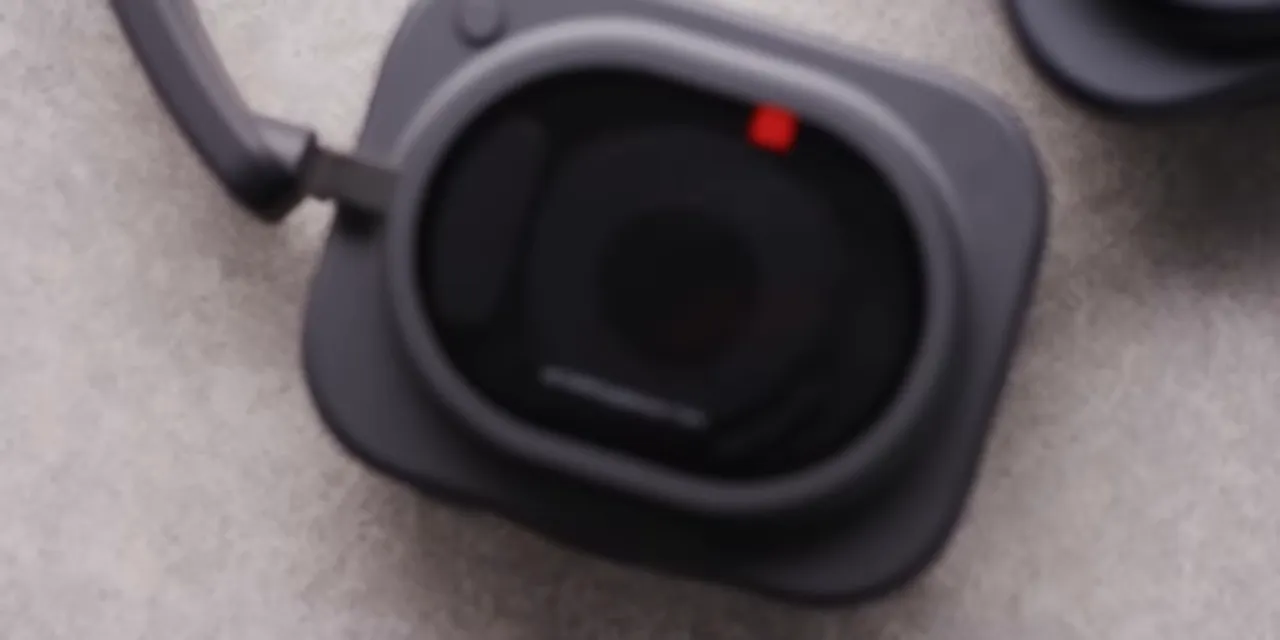 Close-up of a squared Nothing headphone ear cup with a transparent outer panel and red marker