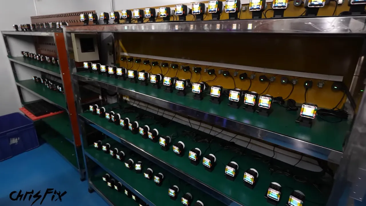 Shelves holding rows of powered dash cameras with illuminated displays and connected power cables