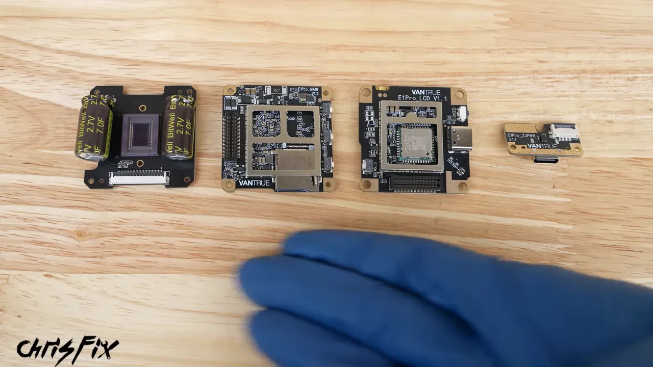 Four dash camera circuit boards arranged on a wooden work surface