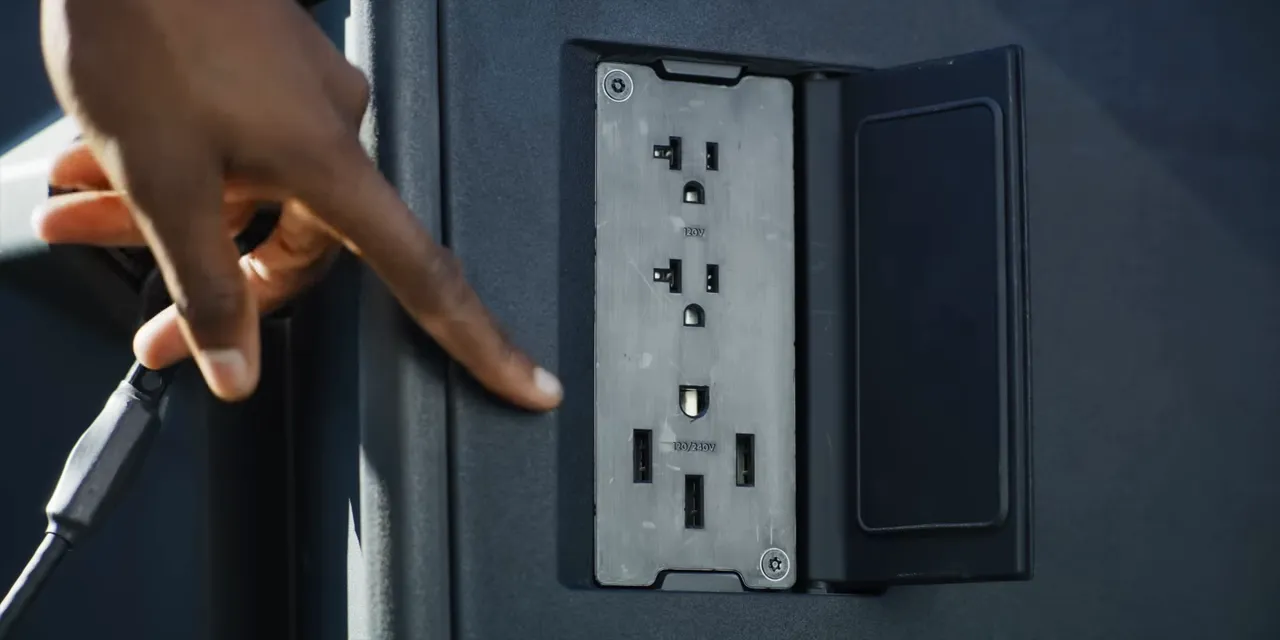 Open power outlet panel inside the Cybertruck bed