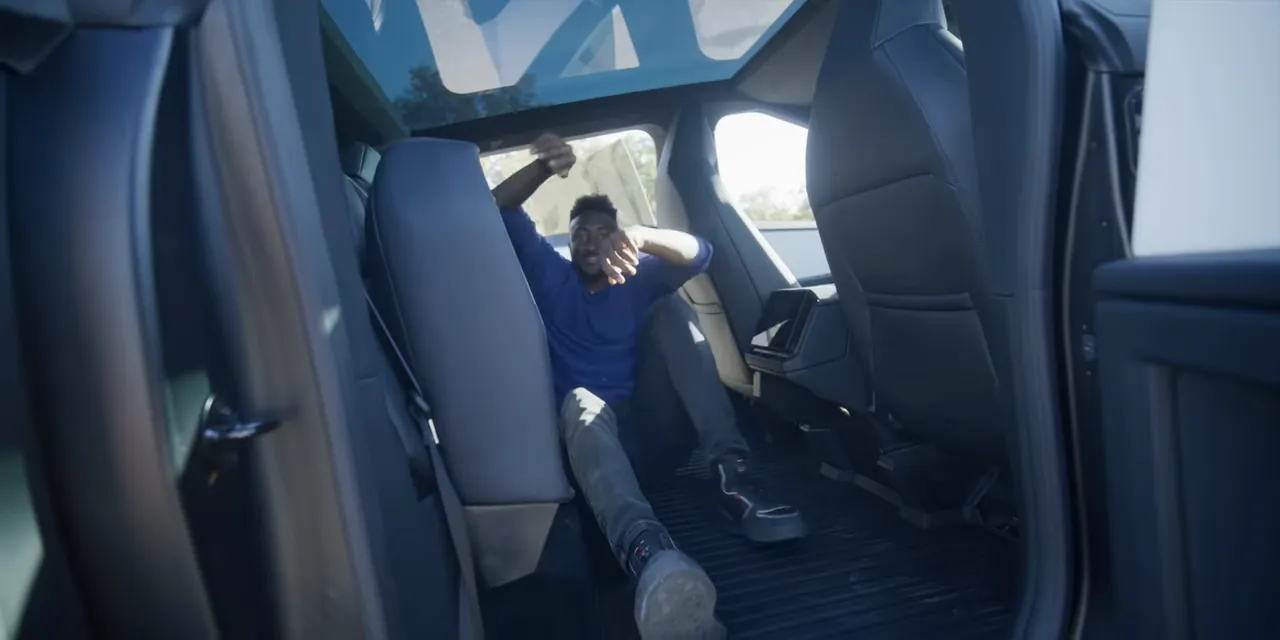 Cybertruck rear seat cushions folded upward above the exposed cabin floor