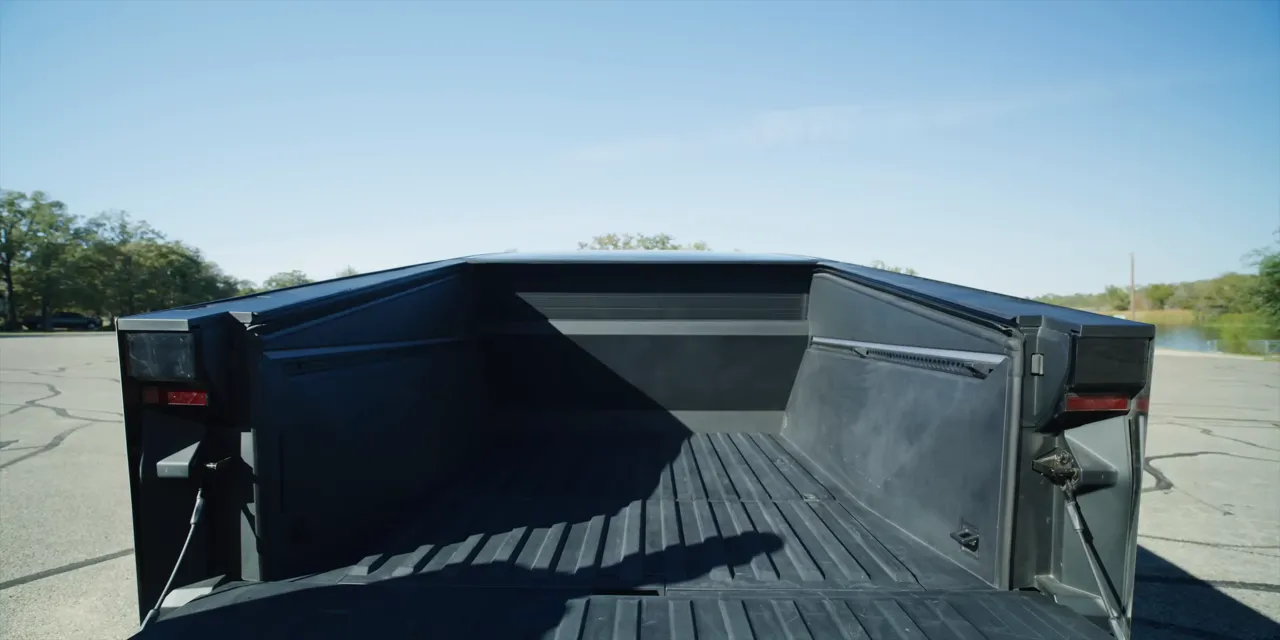 Cybertruck's lined bed with the tailgate lowered and tonneau cover retracted