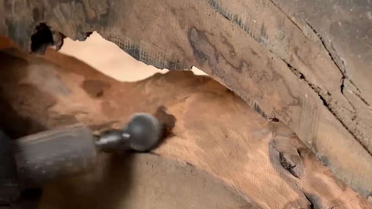 Spherical carving burr removing material from a recessed area of the walnut slab
