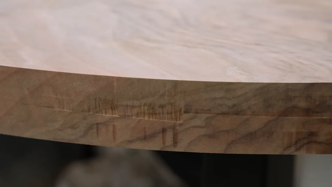 Close-up of rough chatter marks around the walnut tabletop edge