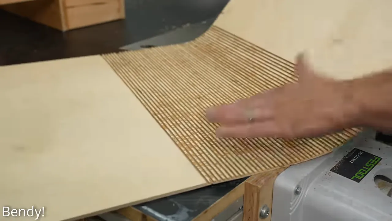 Thin plywood with closely spaced kerf cuts bending around a curved wooden form