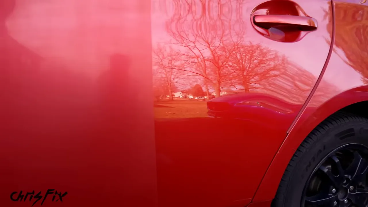 Red Prius door with dull paint on one side and reflective polished paint on the other