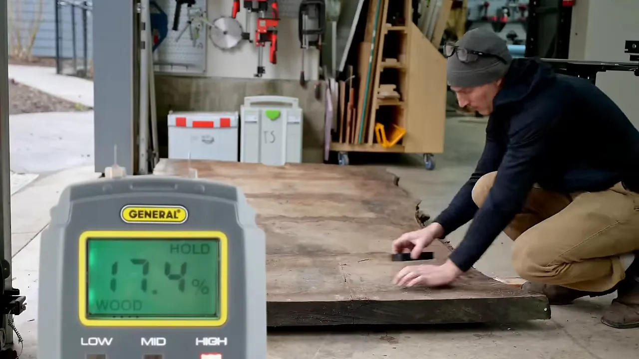 Moisture meter display reading 7.4 on the walnut slab