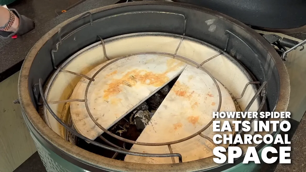 Two ceramic half-moon deflectors sitting low inside a Big Green Egg on a metal support