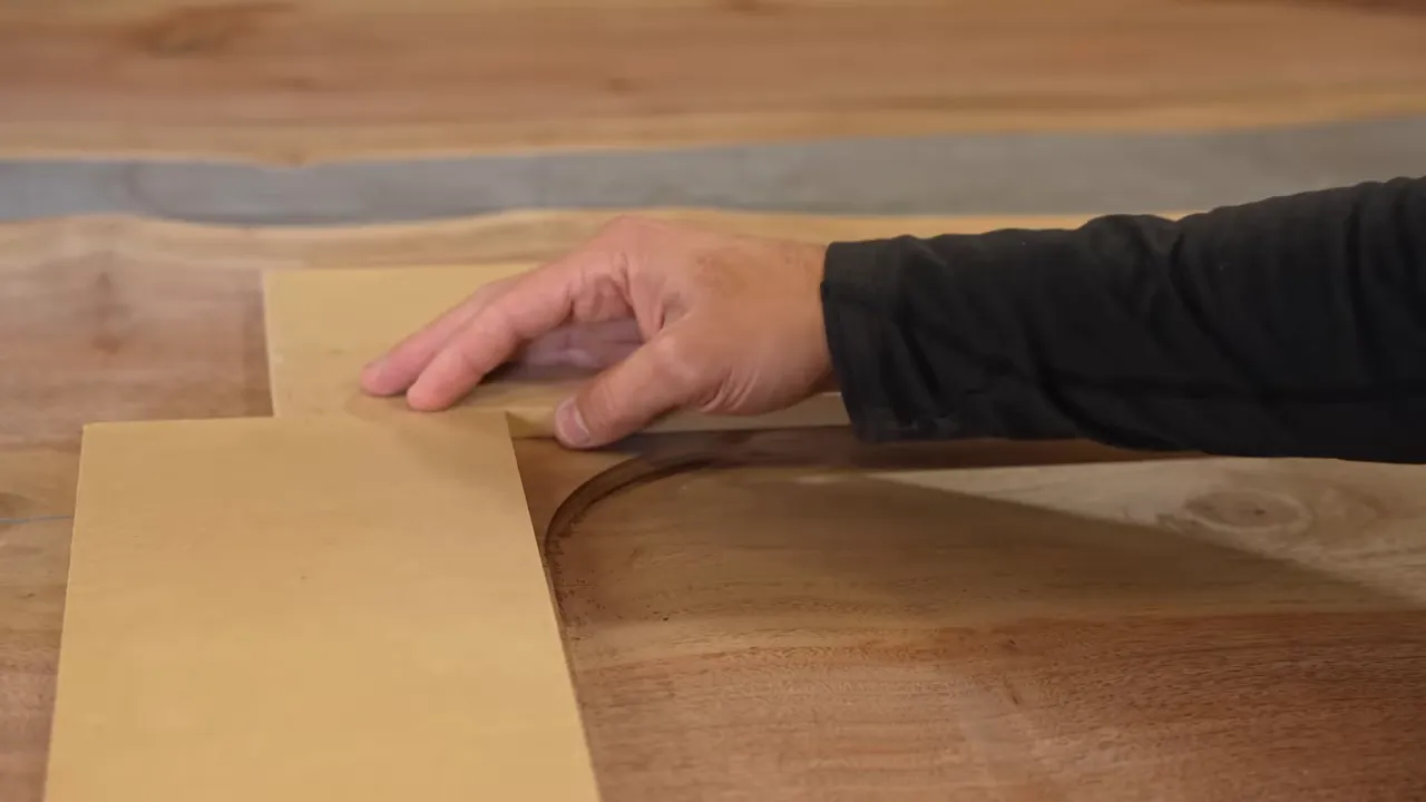 Straightedge guides positioned around a shallow recessed area in the wood tabletop