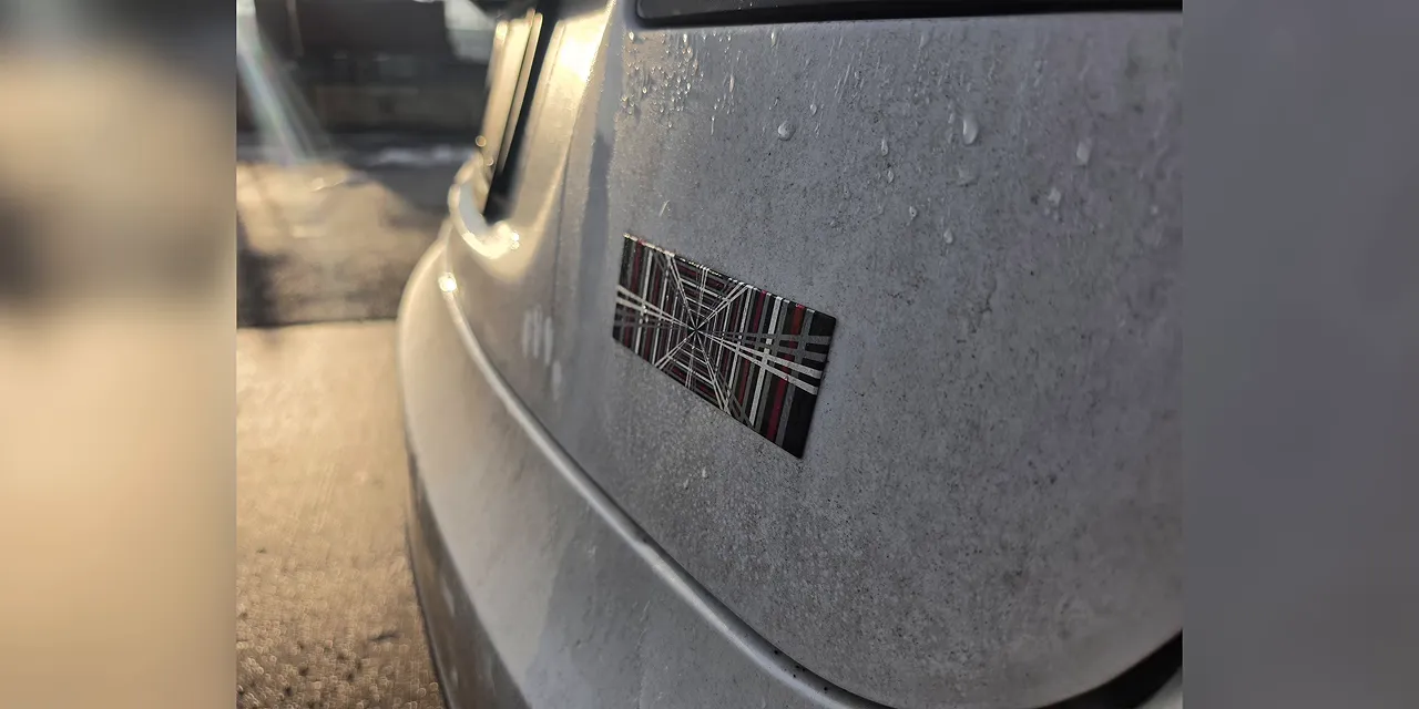 Sample photograph of water droplets on a white car with a softly blurred background