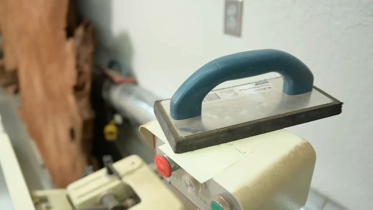 Concrete float with a blue handle resting on the jointer