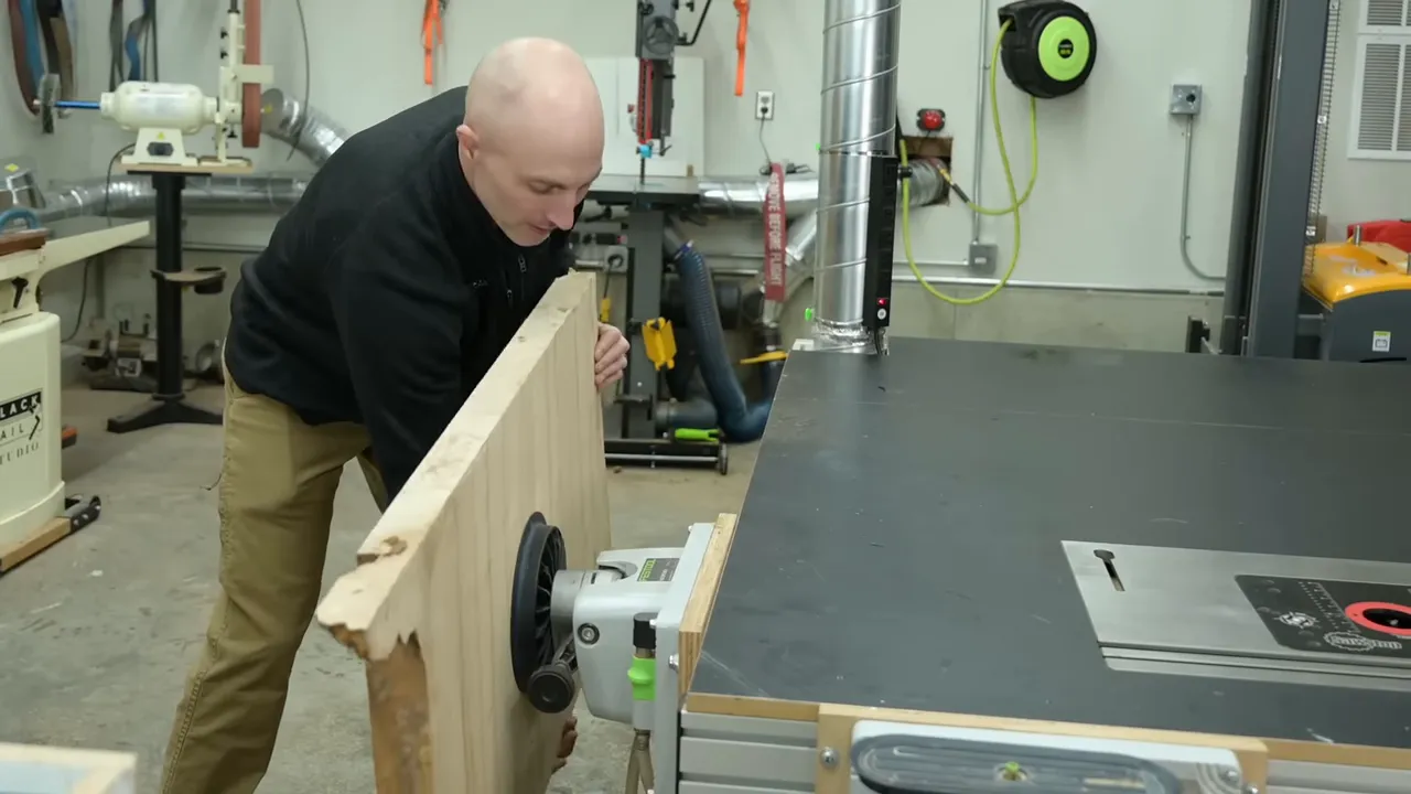 Wood panel held vertically beside the outfeed table on vacuum clamps