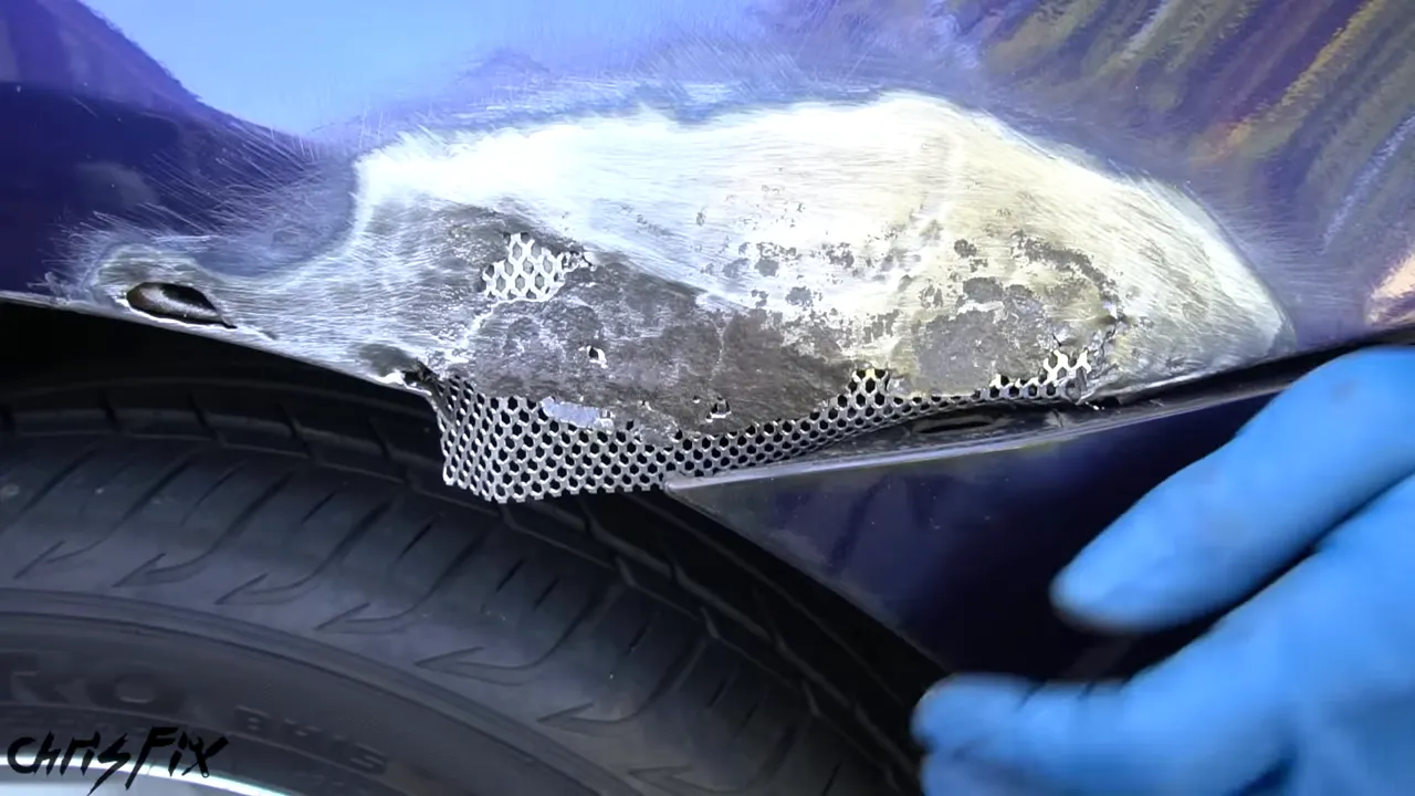 Patch mesh behind the sanded wheel-arch corner with the bumper positioned below it