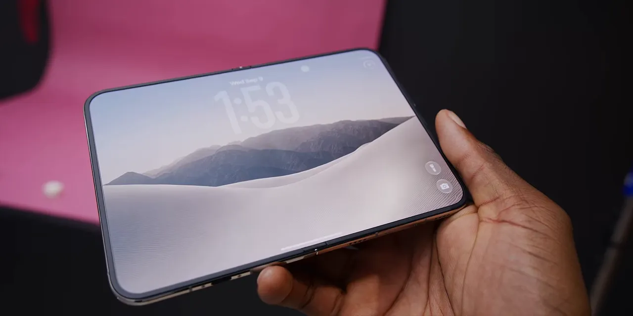 Unfolded iPhone Duo tilted at a shallow angle with a landscape wallpaper across the display