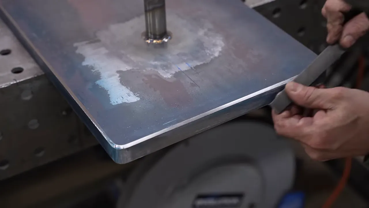 Close-up of the steel base with a clean chamfered edge and welded support