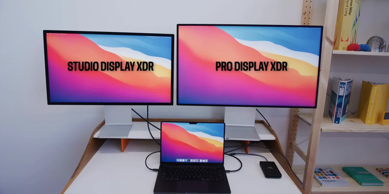 Studio Display XDR and larger Pro Display XDR side by side above a MacBook Pro, with both monitors labeled