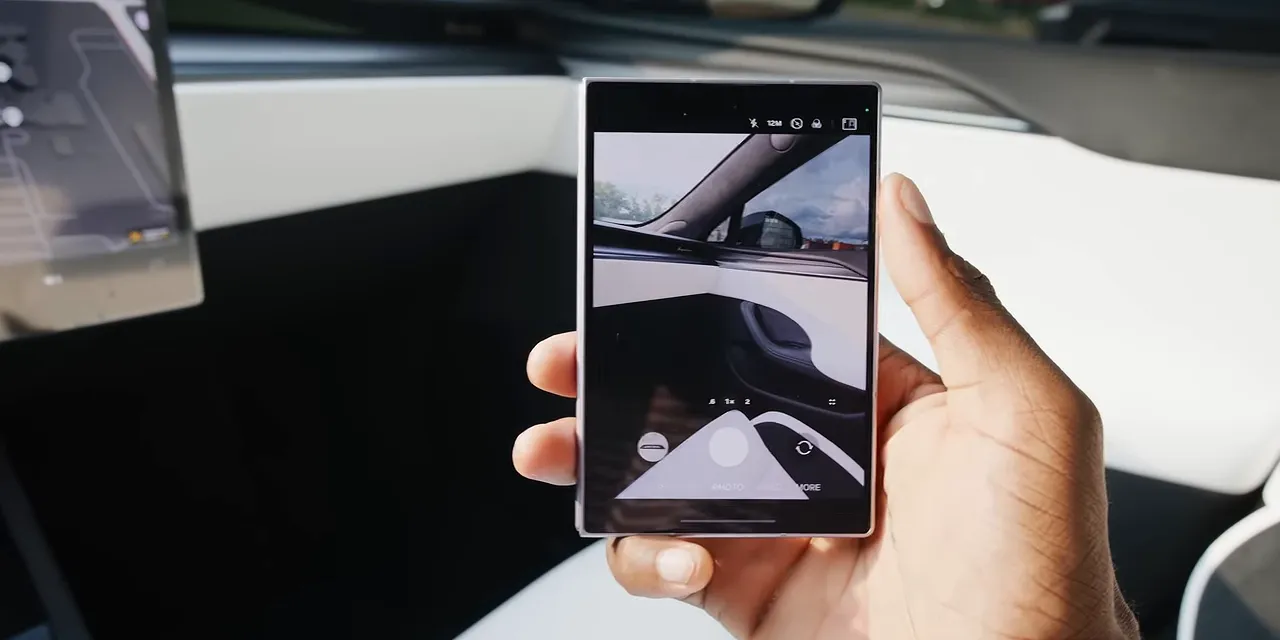 Folded phone held in one hand with the camera app open