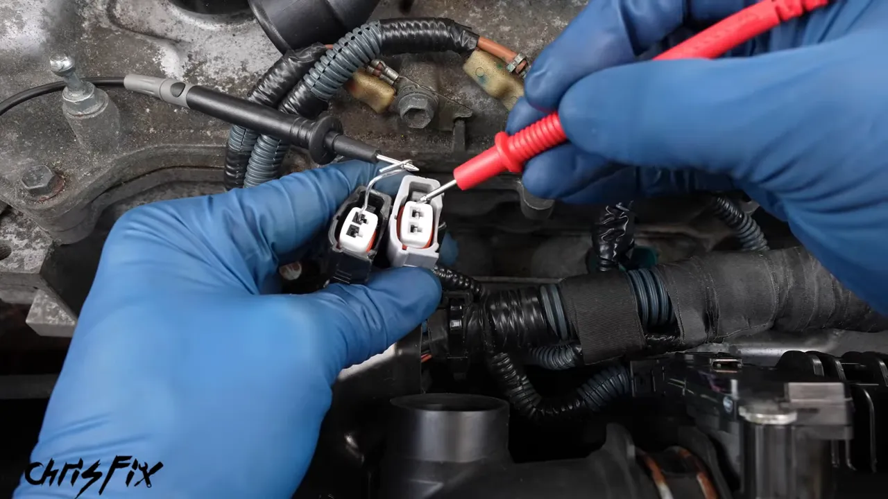 Multimeter probes checking terminals on two unplugged fuel injector connectors