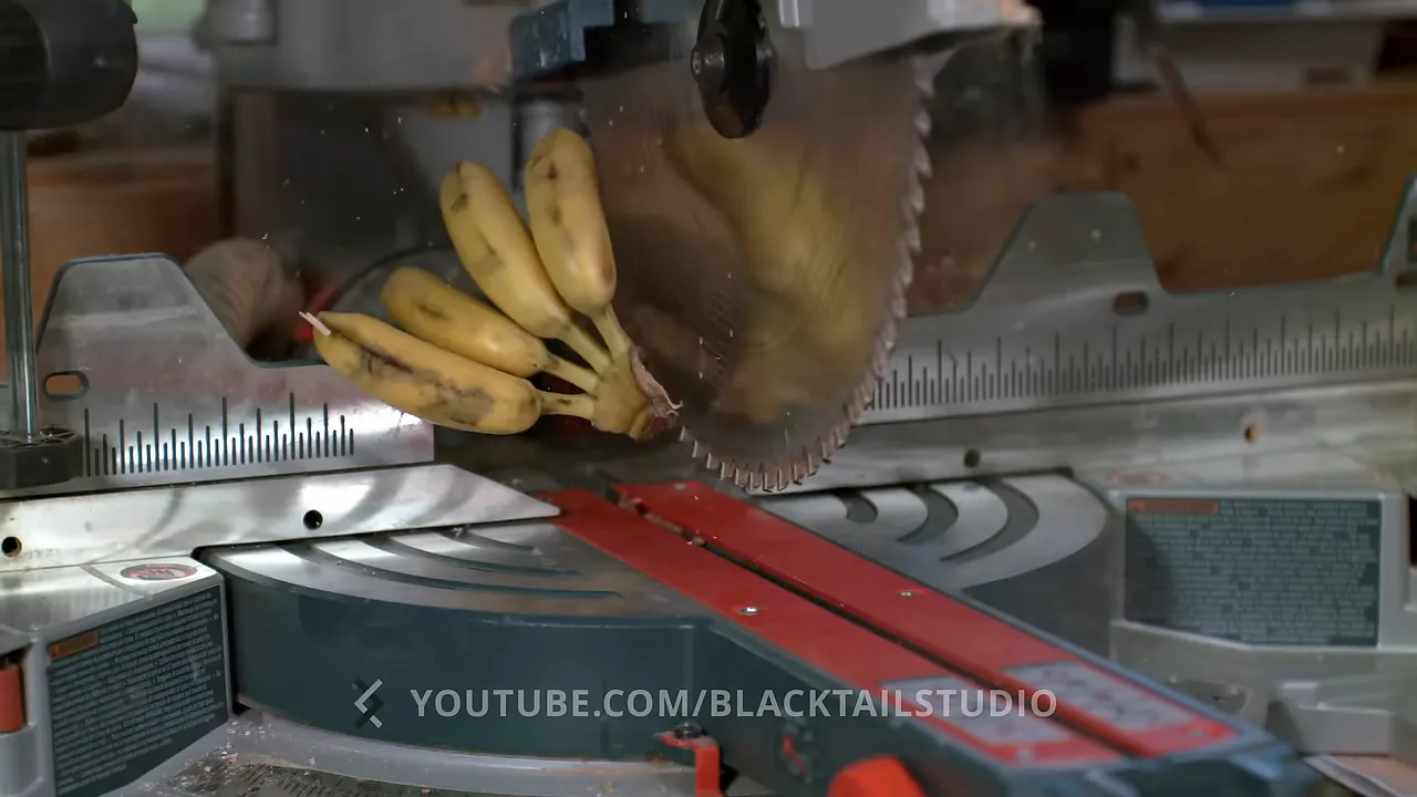 Bananas and a small wood block lifted beside an exposed miter saw blade