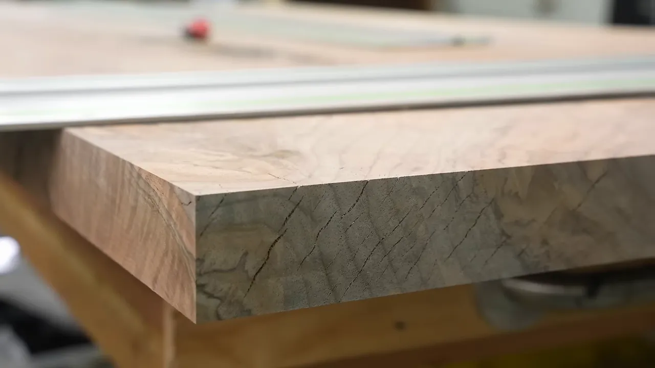 Multiple cracks visible across the cut end grain of a thick walnut slab