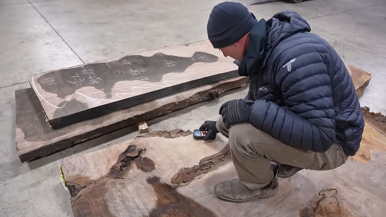 A pinless moisture meter held against a walnut slab