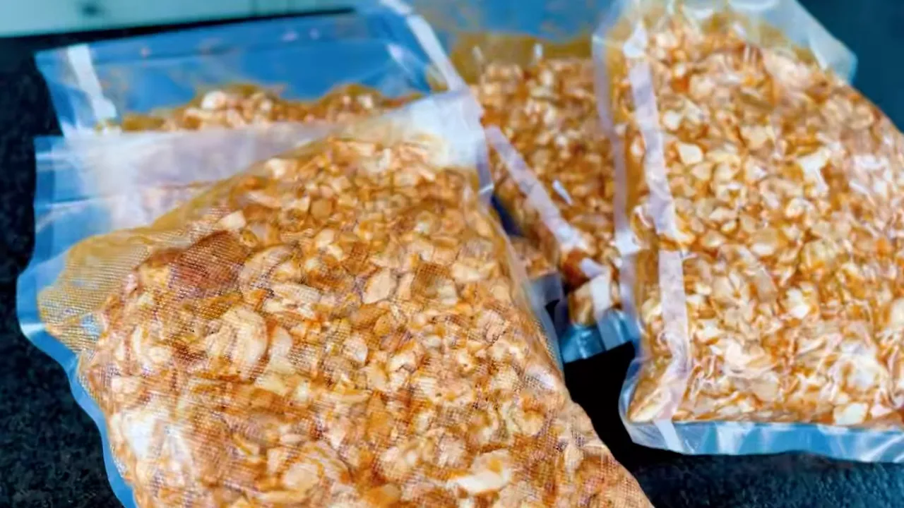 Flattened vacuum-sealed bags filled with chopped seasoned chicken
