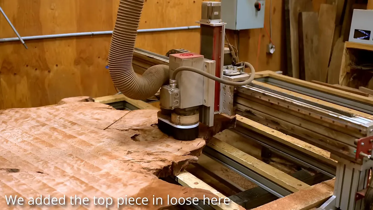CNC router surfacing the redwood slab with its loose tip positioned alongside it